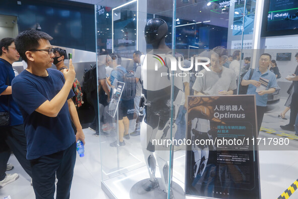 A Unitree robot dog and a model walk on the runway during Fashion Week in Shanghai, China, on October 27, 2024. 