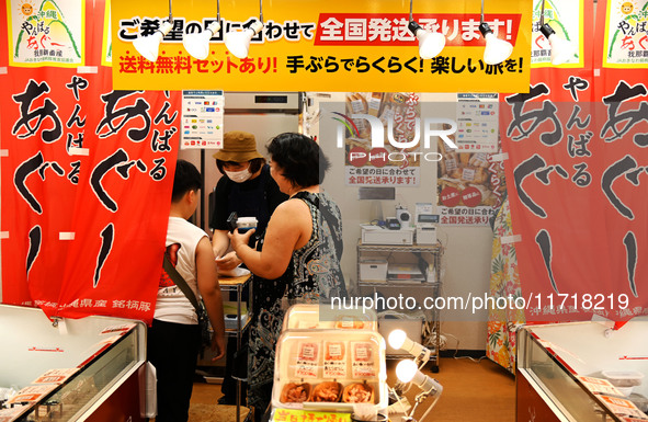 People shop at Heimitsu Shop Street in Naha, Japan, on October 28, 2024. 