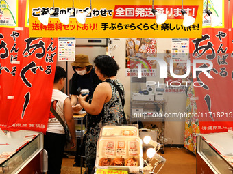 People shop at Heimitsu Shop Street in Naha, Japan, on October 28, 2024. (