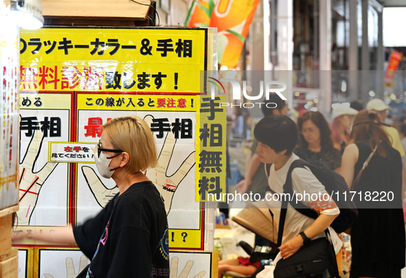 People shop at Heimitsu Shop Street in Naha, Japan, on October 28, 2024. 