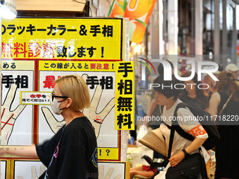 People shop at Heimitsu Shop Street in Naha, Japan, on October 28, 2024. (