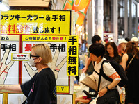 People shop at Heimitsu Shop Street in Naha, Japan, on October 28, 2024. (