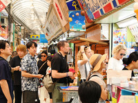 People shop at Heimitsu Shop Street in Naha, Japan, on October 28, 2024. (