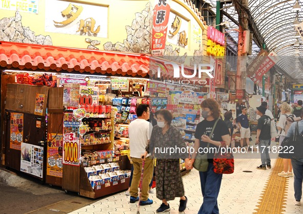 People shop at Heimitsu Shop Street in Naha, Japan, on October 28, 2024. 