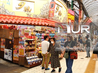 People shop at Heimitsu Shop Street in Naha, Japan, on October 28, 2024. (