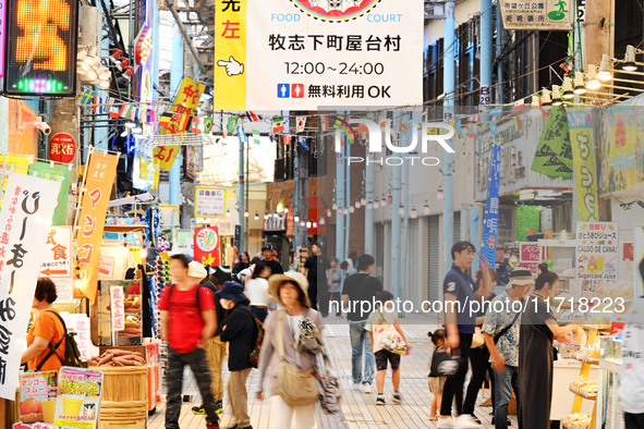 People shop at Heimitsu Shop Street in Naha, Japan, on October 28, 2024. 