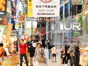 People shop at Heimitsu Shop Street in Naha, Japan, on October 28, 2024. (