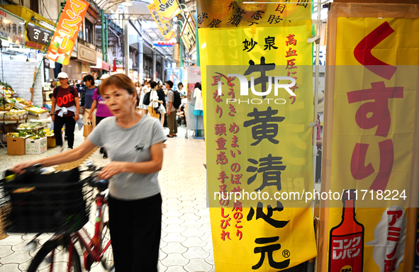 People shop at Heimitsu Shop Street in Naha, Japan, on October 28, 2024. 