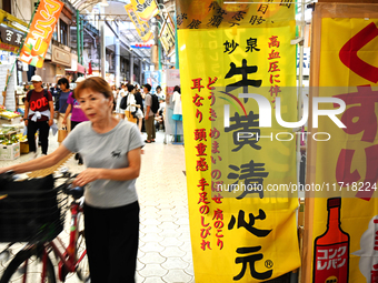 People shop at Heimitsu Shop Street in Naha, Japan, on October 28, 2024. (