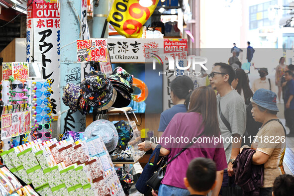 People shop at Heimitsu Shop Street in Naha, Japan, on October 28, 2024. 