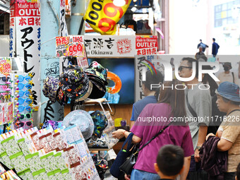 People shop at Heimitsu Shop Street in Naha, Japan, on October 28, 2024. (