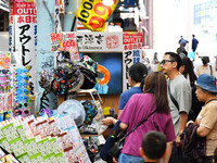 People shop at Heimitsu Shop Street in Naha, Japan, on October 28, 2024. (