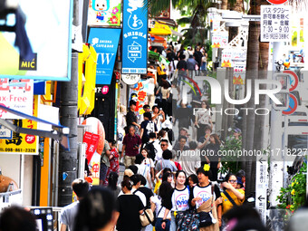 People shop at Heimitsu Shop Street in Naha, Japan, on October 28, 2024. (