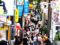 People shop at Heimitsu Shop Street in Naha, Japan, on October 28, 2024. (