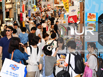 People shop at Heimitsu Shop Street in Naha, Japan, on October 28, 2024. (