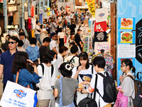 People shop at Heimitsu Shop Street in Naha, Japan, on October 28, 2024. (