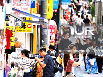 People shop at Heimitsu Shop Street in Naha, Japan, on October 28, 2024. (