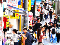 People shop at Heimitsu Shop Street in Naha, Japan, on October 28, 2024. (