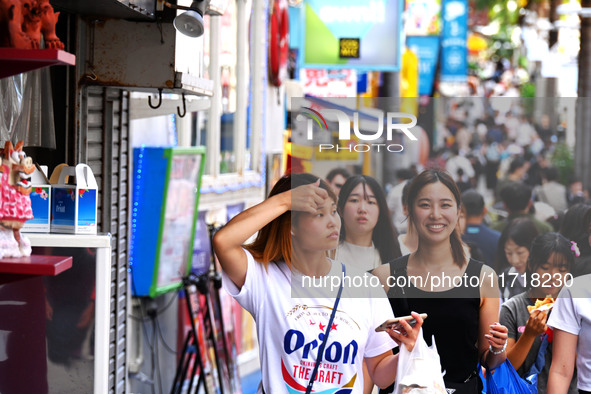 People shop at Heimitsu Shop Street in Naha, Japan, on October 28, 2024. 