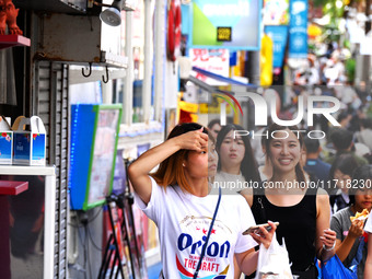 People shop at Heimitsu Shop Street in Naha, Japan, on October 28, 2024. (