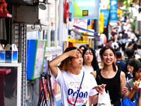 People shop at Heimitsu Shop Street in Naha, Japan, on October 28, 2024. (