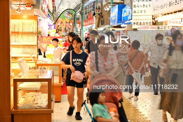 People shop at Heimitsu Shop Street in Naha, Japan, on October 28, 2024. 