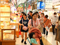 People shop at Heimitsu Shop Street in Naha, Japan, on October 28, 2024. (