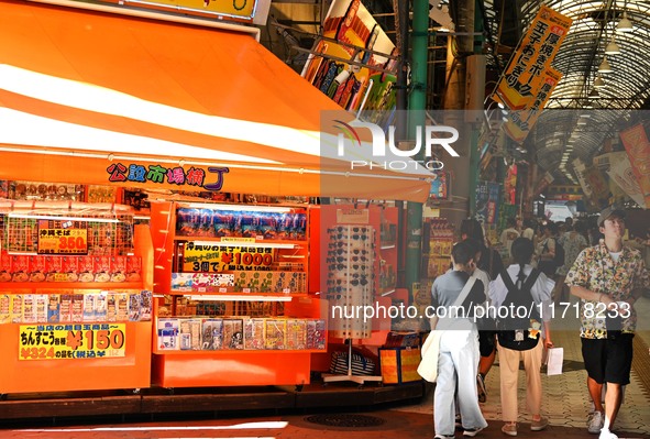 People shop at Heimitsu Shop Street in Naha, Japan, on October 28, 2024. 