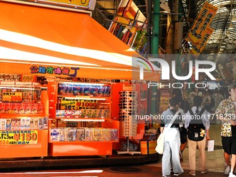 People shop at Heimitsu Shop Street in Naha, Japan, on October 28, 2024. (