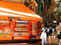 People shop at Heimitsu Shop Street in Naha, Japan, on October 28, 2024. (