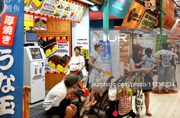 People shop at Heimitsu Shop Street in Naha, Japan, on October 28, 2024. 