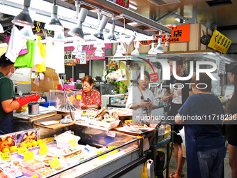 People shop at Heimitsu Shop Street in Naha, Japan, on October 28, 2024. (