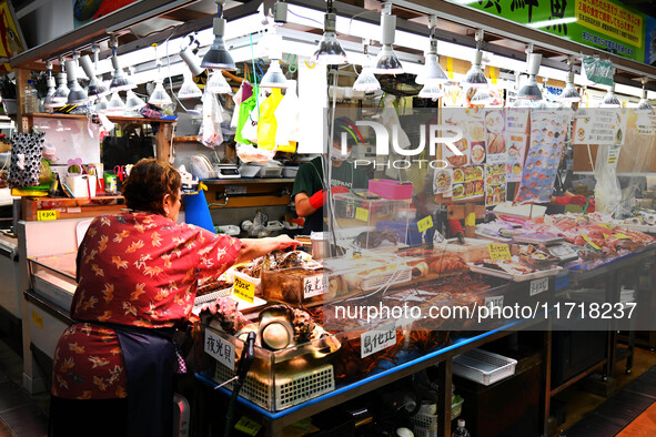 People shop at Heimitsu Shop Street in Naha, Japan, on October 28, 2024. 