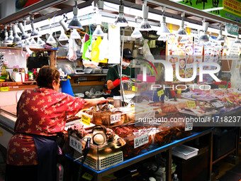 People shop at Heimitsu Shop Street in Naha, Japan, on October 28, 2024. (