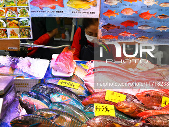 People shop at Heimitsu Shop Street in Naha, Japan, on October 28, 2024. (