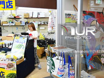 People shop at Heimitsu Shop Street in Naha, Japan, on October 28, 2024. (