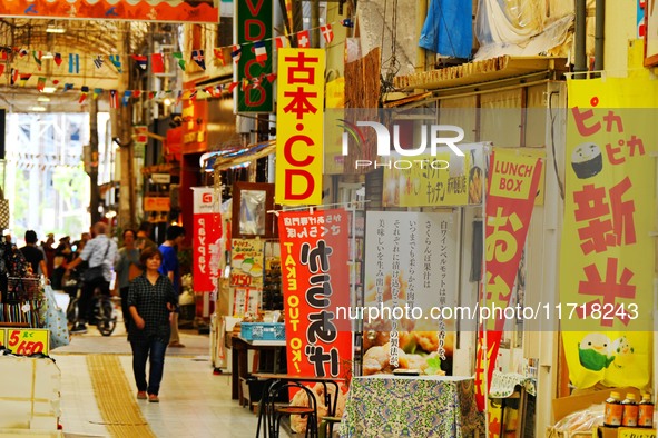 People shop at Heimitsu Shop Street in Naha, Japan, on October 28, 2024. 