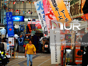 People shop at Heimitsu Shop Street in Naha, Japan, on October 28, 2024. (