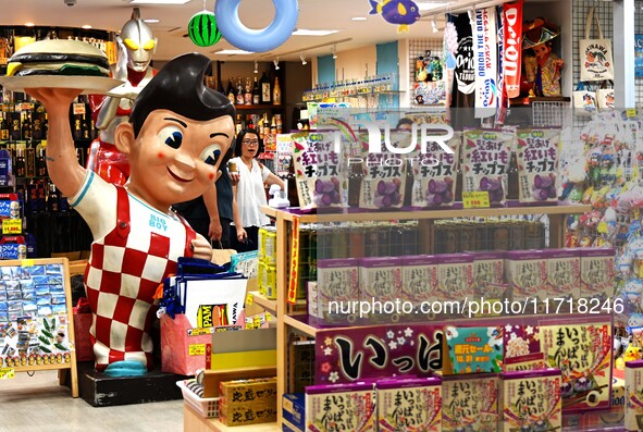 People shop at Heimitsu Shop Street in Naha, Japan, on October 28, 2024. 