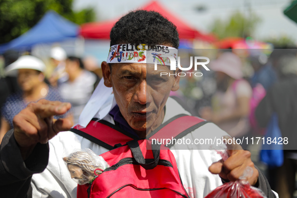 A devotee of Saint Jude Thaddeus attends the Church of San Hipolito to bless the images and give thanks for the favors granted in Mexico Cit...