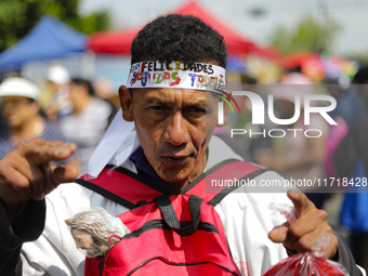 A devotee of Saint Jude Thaddeus attends the Church of San Hipolito to bless the images and give thanks for the favors granted in Mexico Cit...