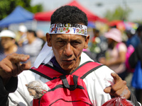 A devotee of Saint Jude Thaddeus attends the Church of San Hipolito to bless the images and give thanks for the favors granted in Mexico Cit...