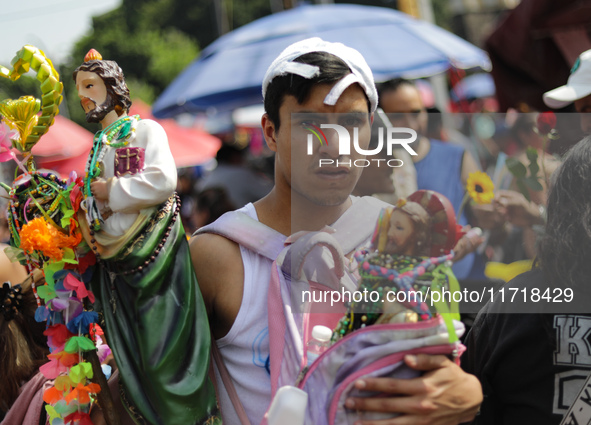 A devotee of Saint Jude Thaddeus attends the Church of San Hipolito to bless the images and give thanks for the favors granted in Mexico Cit...