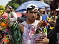 A devotee of Saint Jude Thaddeus attends the Church of San Hipolito to bless the images and give thanks for the favors granted in Mexico Cit...