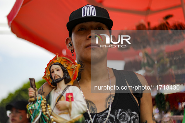 A devotee of Saint Jude Thaddeus attends the Church of San Hipolito to bless the images and give thanks for the favors granted in Mexico Cit...