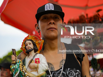 A devotee of Saint Jude Thaddeus attends the Church of San Hipolito to bless the images and give thanks for the favors granted in Mexico Cit...