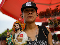 A devotee of Saint Jude Thaddeus attends the Church of San Hipolito to bless the images and give thanks for the favors granted in Mexico Cit...