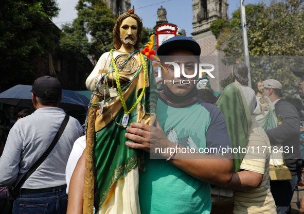 A devotee of Saint Jude Thaddeus attends the Church of San Hipolito to bless the images and give thanks for the favors granted in Mexico Cit...