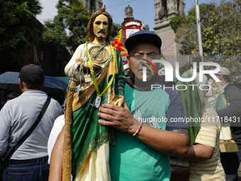 A devotee of Saint Jude Thaddeus attends the Church of San Hipolito to bless the images and give thanks for the favors granted in Mexico Cit...