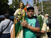 A devotee of Saint Jude Thaddeus attends the Church of San Hipolito to bless the images and give thanks for the favors granted in Mexico Cit...